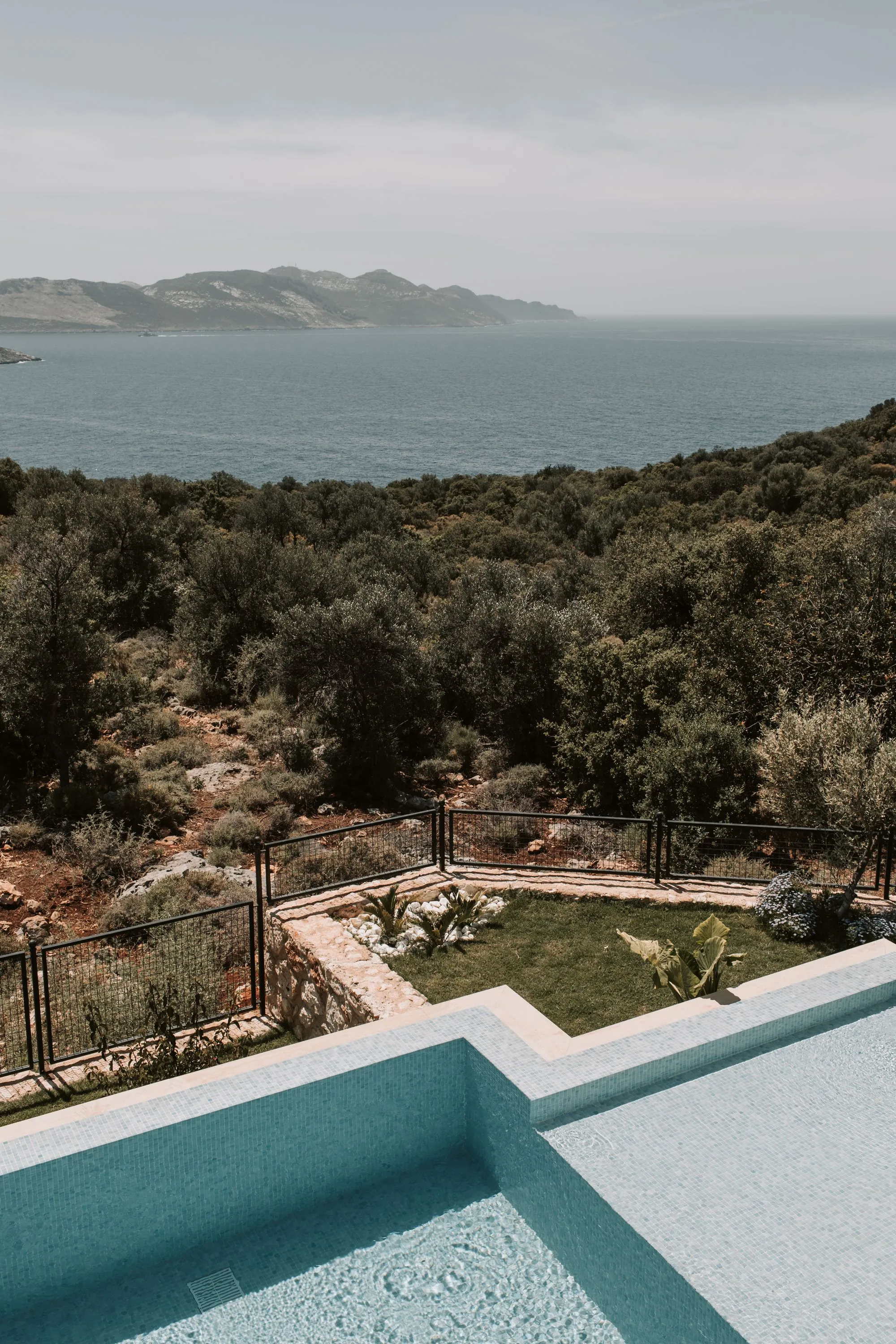 Η πισίνα πάνω από τους πράσινους λόφους και τον κόλπο